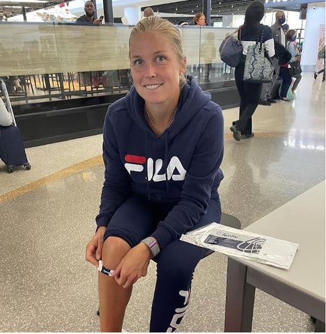 Tennis Star Shelby Rogers applying Firefly Recovery Device before her flight.